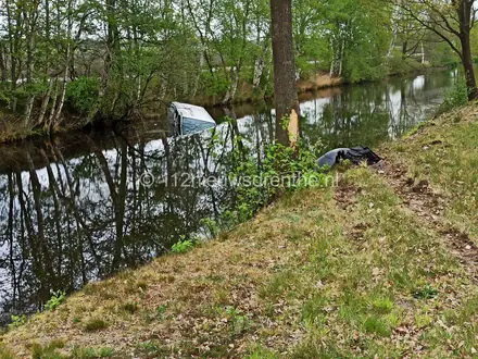 Bestelbus rijdt tegen boom en eindigt te water — foto 1 van 3
