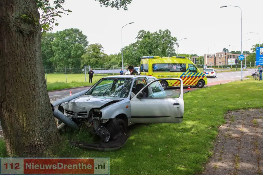 Auto rijdt verkeersbord en lantaarnpaal omver en botst tegen boom in Emmen. Bestuurder gewond, weg deels afgesloten
